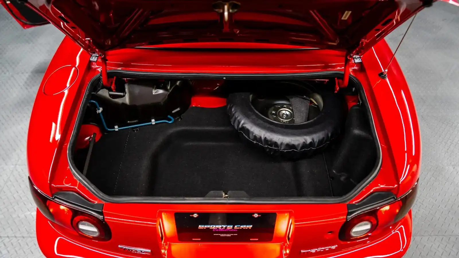 Open Miata trunk showing available cargo space for a driving tour